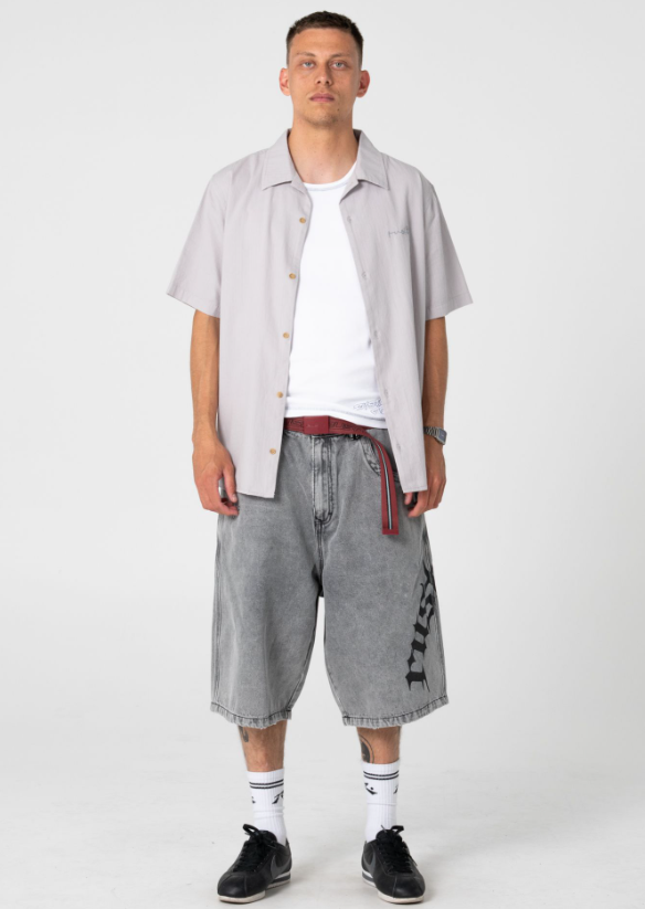 Rusty Tweaking Baggy 26" Men's Denim Shorts in london summer colourway on model in open short sleeve shirt from the front
