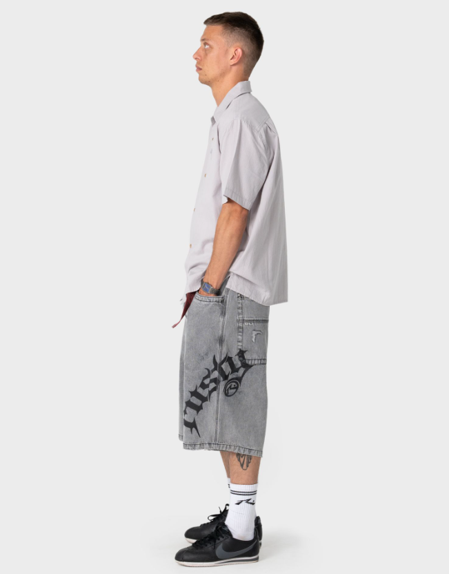 Rusty Tweaking Baggy 26" Men's Denim Shorts in london summer colourway on model in shirt from the side