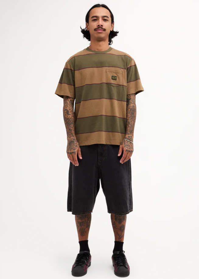 RVCA Dayshift Stripe Tee in fatigue colourway on model in black denim shorts
