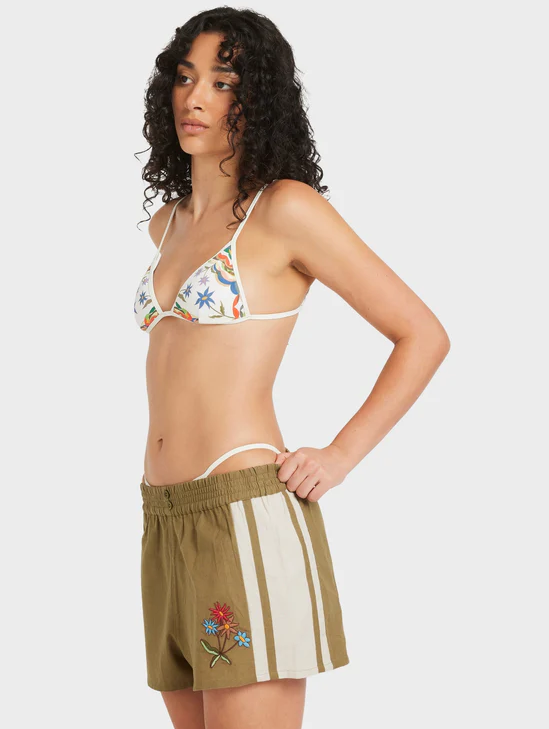 RVCA Mel G Elastic Waist Shorts in olive form side on model in white bikini