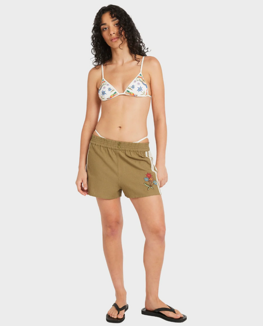 RVCA Mel G Elastic Waist Shorts in olive on model in white bikini top from front