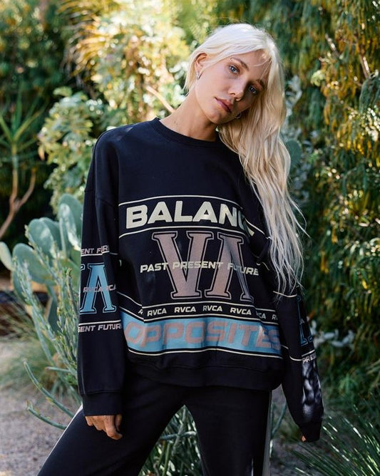 RVCA Puck It Pullover Crew Womens Sweatshirt in black on blonde model outside