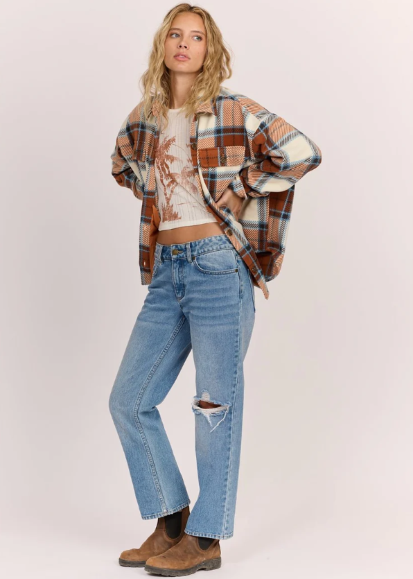 Sisstrevolution Washed Ashore Women's Fleece in terracotta colourway on model in blue jeans from frontside view