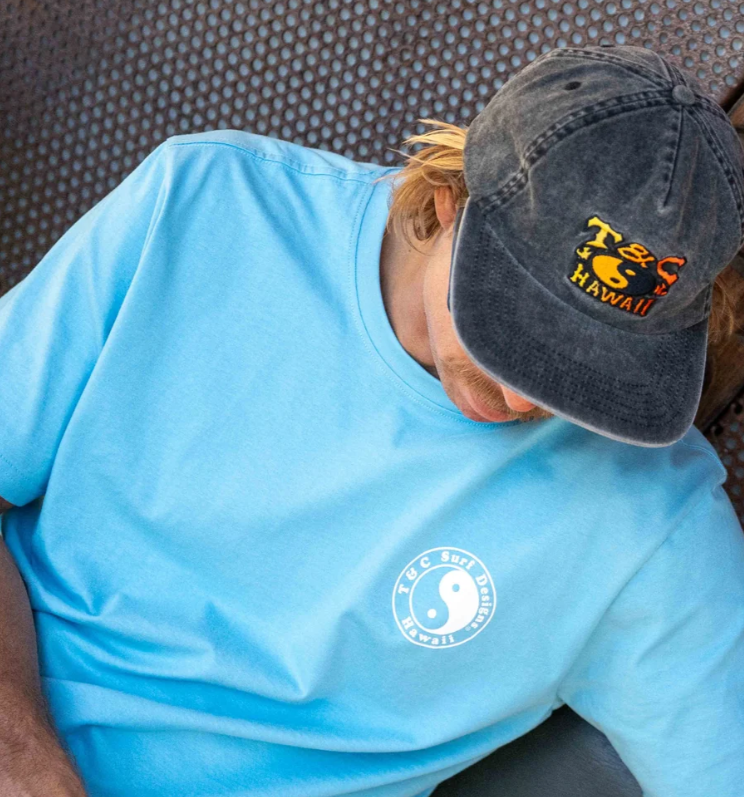 T & C OG Logo Men's T-Shirt in light blue on man in town and country cap from front