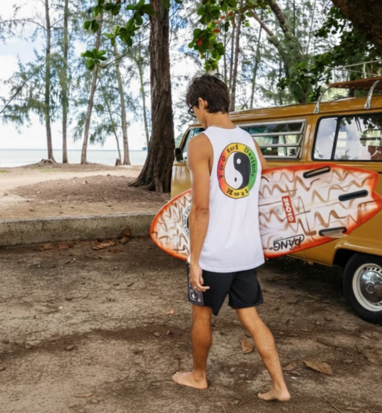 T & C OG Men's Singlet in white on model carrying a surfboard 