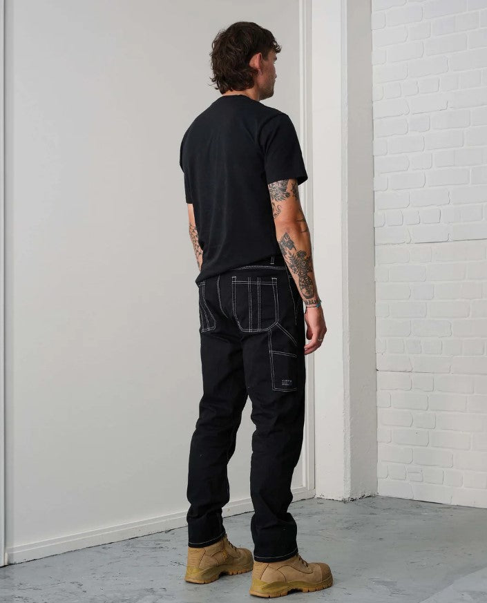 X-DMG X02 Relaxed Fit Work Pants in black with white contrast stitching from back on male model